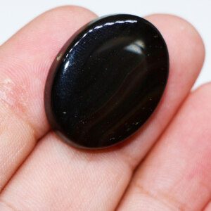 Black Agate Stone Held in Hand