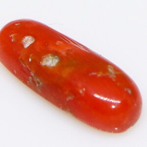 Fiery red Ratna Munga gem, close-up view.