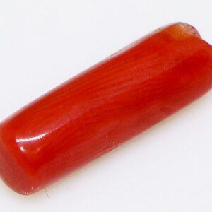 Close-up of a sparkling 4-carat red coral loose stone on a white background.