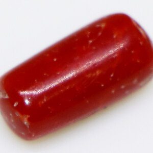 Fiery red, certified Moonga loose gemstone closeup.