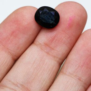 Sapphire oval loose gemstone in hand