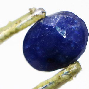 Loose Blue Gemstone held with tweezers