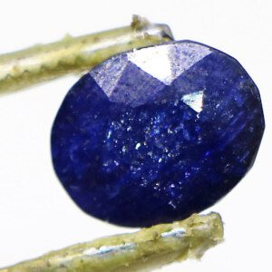 Loose Blue Sapphire Stone held with tweezers