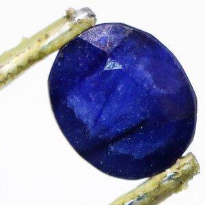 Faceted blue sapphire loose stone displaying its captivating depth.