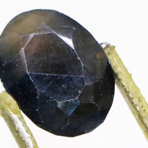 African Neelam loose gemstone in hand for jewelry making