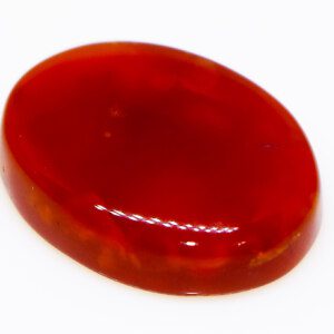 Close-up of a polished Red Agate loose gemstone, highlighting its smooth texture.