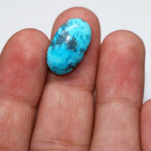 Close-up of turquoise pendant stone in hand