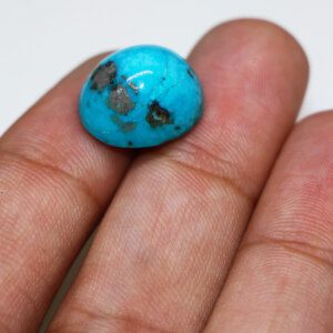 Hand holding men's turquoise stone